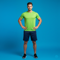 Man wearing a green shirt and navy shorts on a blue background