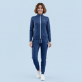 Woman wearing a blue tracksuit with a logo on a light blue background